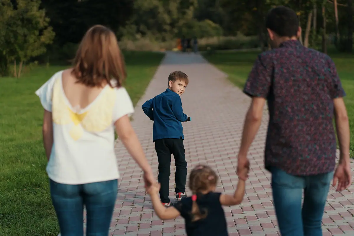 Family walking together along a park path