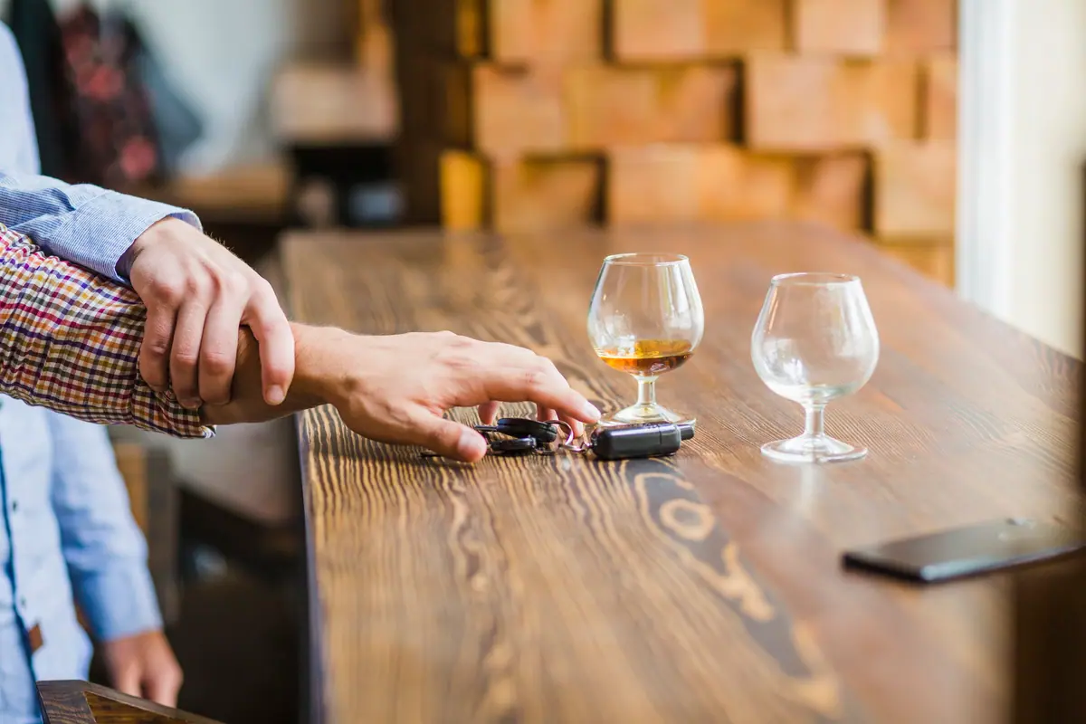 Car keys and drinks on a bar counter